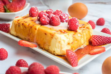 Condensed milk flan with raspberries and strawberries.