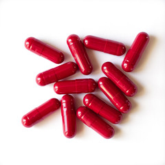 red medical capsules on a white background, isolate