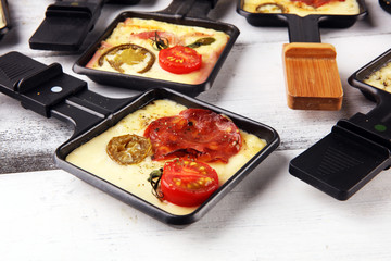 Delicious traditional Swiss melted raclette cheese on diced boiled or baked potato.