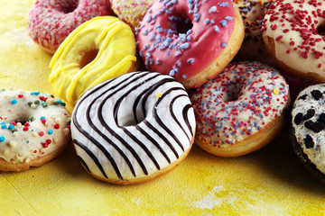 donuts in different glazes with chocolate, sprinkles and stripes