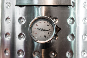 Thermometer on a steel wine tank for wine fermentation at a winery
