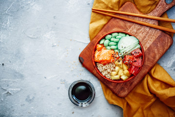 Raw Organic Ahi Tuna Poke Bowl with Rice and Veggies close-up on the table