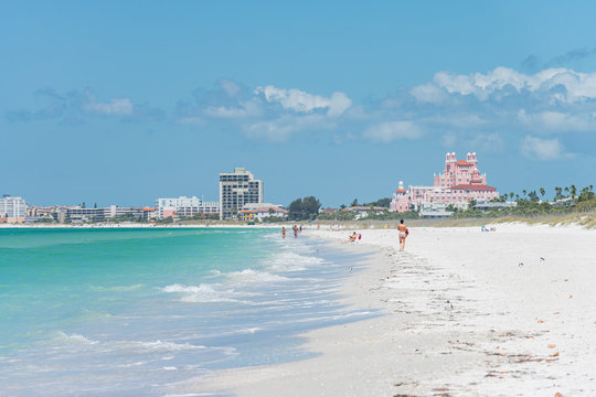 People walking white sandy beach
