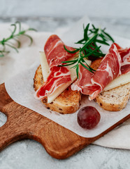 Slices of bread with spanish serrano ham served as tapas