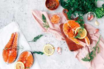 Delicious portion of fresh salmon fillet with aromatic herbs, spices - healthy food, diet or cooking concept