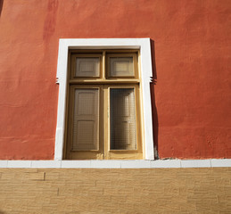 Fototapeta na wymiar A simple single window in a brown wall.