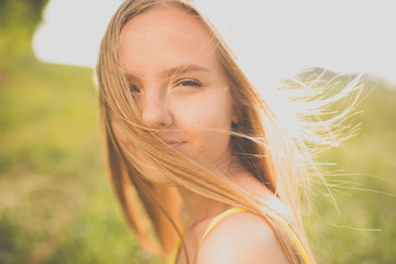 Portrait of young, pretty  woman outdoor on a summer sunny day