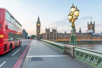 Obraz na płótnie Canvas Red Bus speeds up along Westminster Bridge - London, UK
