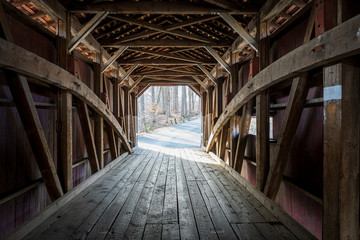 Looking down the inside of a covered wooden bridge in rural Lancaster County, Pennsylvania, USA.
