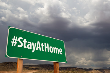 #Stay At Home Green Road Sign Against An Ominous Cloudy Sky