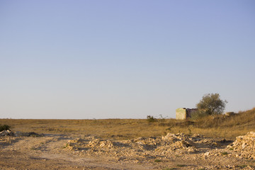 Steppe landscape with house and tree at the road construction repairs
