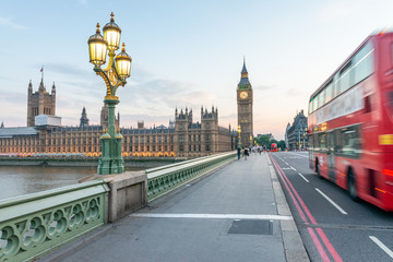 Fototapeta na wymiar LONDON - JULY 3, 2015: Red Double Decker Bus speeds up along city streets