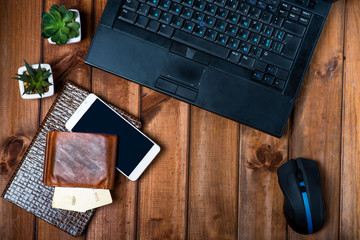 online shopping concept, laptop on a wooden table, phone, bank cards