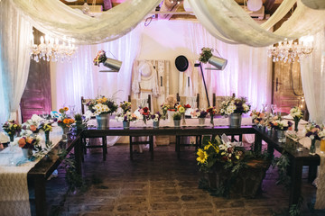 Fototapeta na wymiar Decorated tables with candles and floral arrangements for celebration