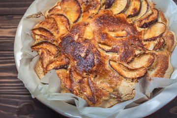 Delicious apple pie freshly baked at home in the oven. Apple Charlotte Homemade baking. Vegan cake in a baking dish. top view, flat lay