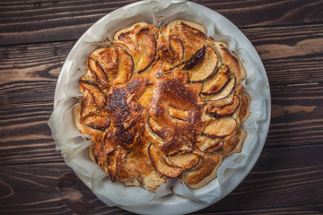 Delicious apple pie freshly baked at home in the oven. Apple Charlotte Homemade baking. Vegan cake in a baking dish. top view, flat lay