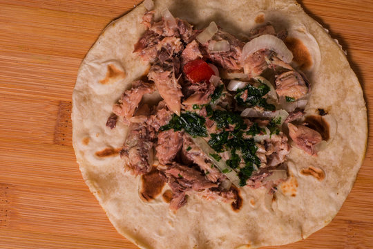 A piadina with fish oinon and parley