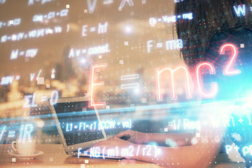 Double exposure of woman hands typing on computer and formula hologram drawing. Education concept.