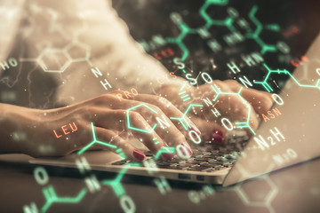 Double exposure of woman hands typing on computer and formula hologram drawing. Education concept.