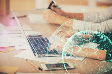 Double exposure of woman hands typing on computer and social network theme hologram drawing. People...
