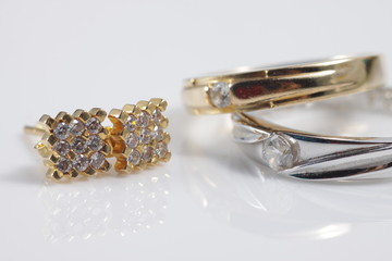 Close up shot of fine gold jewellry set that consist of earrings and marriage / wedding rings