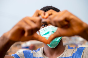 young handsome african nigerian man wore face mask preventing, prevent, prevented himself from the...