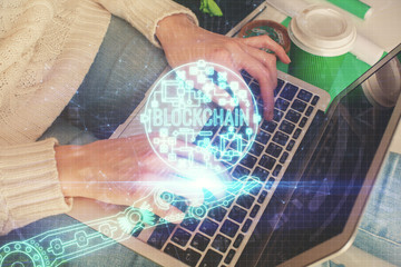 Fototapeta na wymiar Double exposure of woman hands typing on computer and crypto market theme hologram drawing. Blockchain concept.