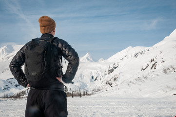 Fototapeta na wymiar Man Gazing at Snowy Mountains in Alaska