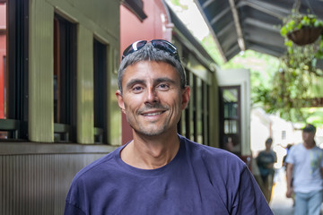 Happy man ready for train journey on Kuranda train, Australia