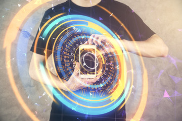 Double exposure of man's hands holding and using a digital device and tech theme hologram drawing. Technology concept.