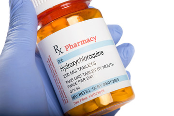 Generic Medication Hydroxychloroquine Prescription Bottle Held By Gloved Hand