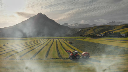 ICELAND - AUGUST 2019: Tractor working in the meadows of Skogar in summer season