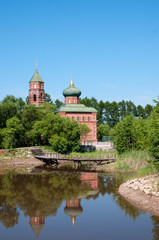Fototapeta na wymiar Russian village, summer landscape lake and old Orthodox Church