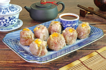 Dim sum : Phuket traditional Fujian style pork dim sum, served with red hot pepper chili sauce and Chinese tea.Famous delicious Thai-Chinese cuisine in Phuket Thailand, Selective focus.