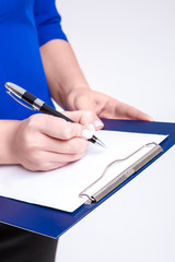 Closeup of Hands of Busy Female Entrepreneur in Blue Jacket Posing With Notepad and making Notes. Posing in Studio on White.