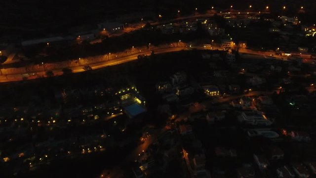 Aerial drone vertical view of Monaco Monte Carlo streets and buildings French Riviera Cote d'Azur coastline at night