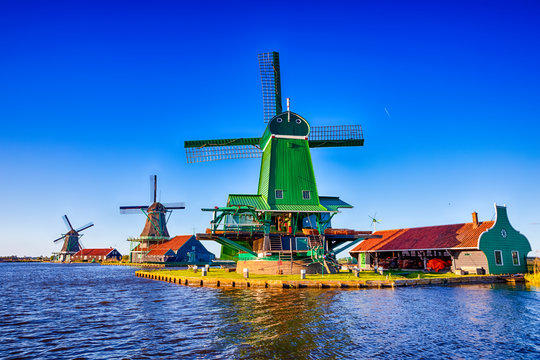 Travel Ideas.Line of Traditional Dutch Windmills in the Village of Zaanse Schans at Daytime in the Netherlands