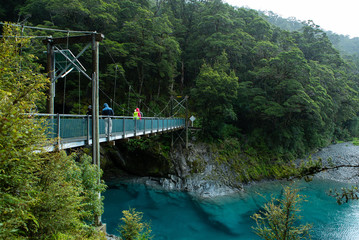 Fototapeta premium Bridge over river at blue pools track in New Zealand