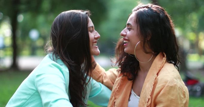Cute LGBT lesbian couple in affectionate tender moment flirting together