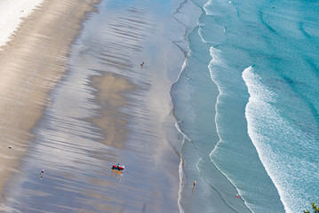 Beach sea view, aerial. A New Zealand fisherman uses fishing torpedo, is a popular option for deploying snapper long lines well offshore.