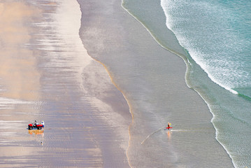 Beach sea view, aerial. A New Zealand fisherman uses fishing torpedo, is a popular option for deploying snapper long lines well offshore.