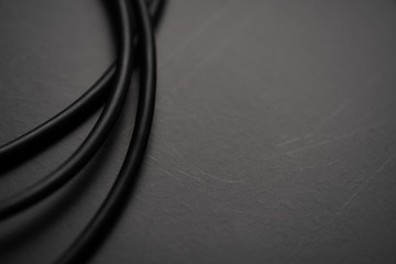 Black wire on black background.