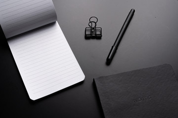 Black style set: notepad, pen and paper clips on Black background