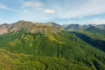 aerial view of Kamchatka volcanos, green valleys, snow and ice and the wonderful view of pure nature.