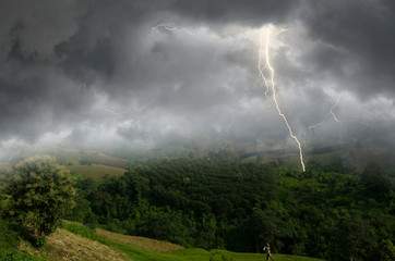 Naklejka na ściany i meble Lightning storm over the mountains in monsoon season
