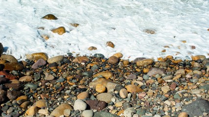 Foaming White Ocean Flowing up Against Rocks