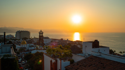 Amazing Orange Sunset Over Blue Ocean on a Rooftop view of Old Town in Puerto Vallarta Mexico