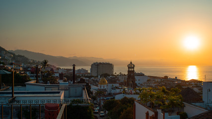 Amazing Orange Sunset Over Blue Ocean on a Rooftop view of Old Town in Puerto Vallarta Mexico