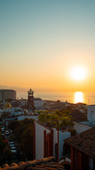 Amazing Orange Sunset Over Blue Ocean on a Rooftop view of Old Town in Puerto Vallarta Mexico