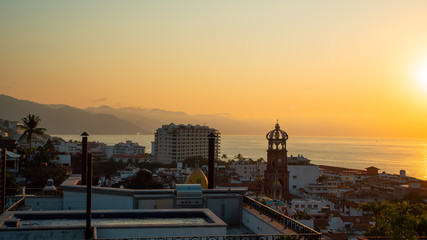 Amazing Orange Sunset Over Blue Ocean on a Rooftop view of Old Town in Puerto Vallarta Mexico